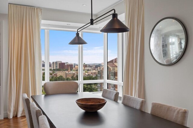 dining area featuring parquet flooring