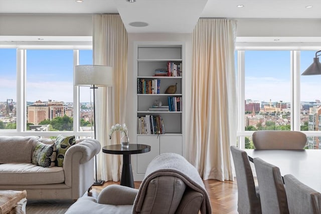 interior space featuring built in shelves and parquet flooring