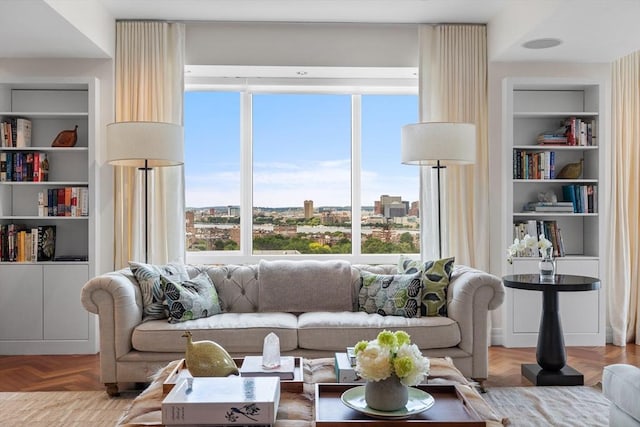 living room with built in features and light parquet floors