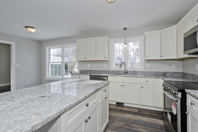 kitchen with decorative light fixtures, white cabinetry, sink, dark hardwood / wood-style flooring, and stainless steel appliances