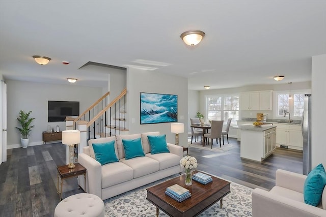 living room featuring sink and dark hardwood / wood-style floors