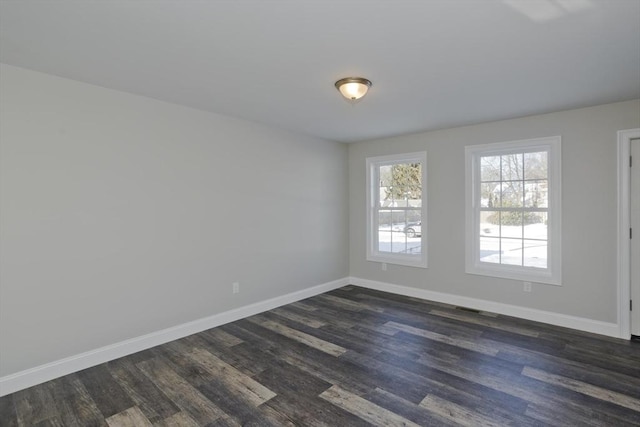 spare room with dark hardwood / wood-style floors