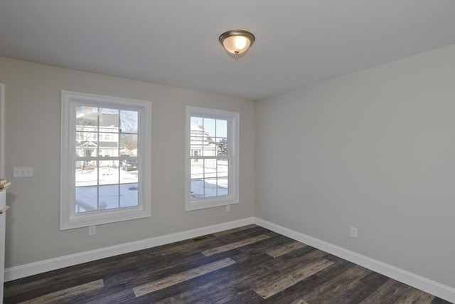 unfurnished room with dark wood-type flooring