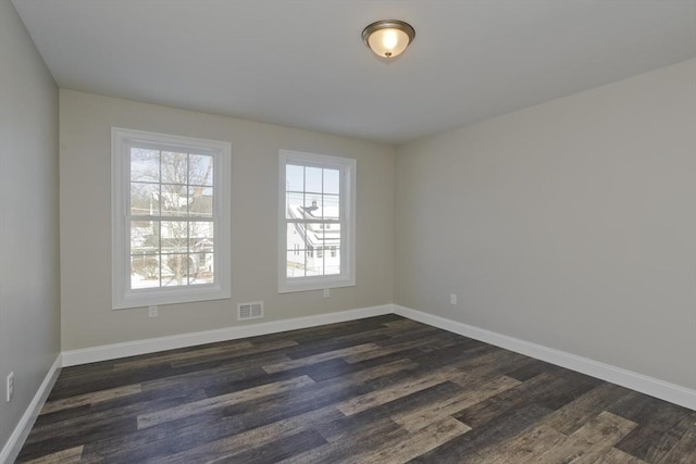 spare room featuring dark hardwood / wood-style floors