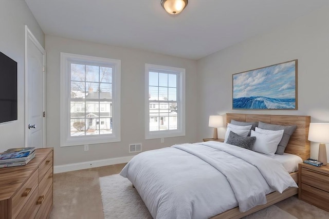 bedroom with light colored carpet