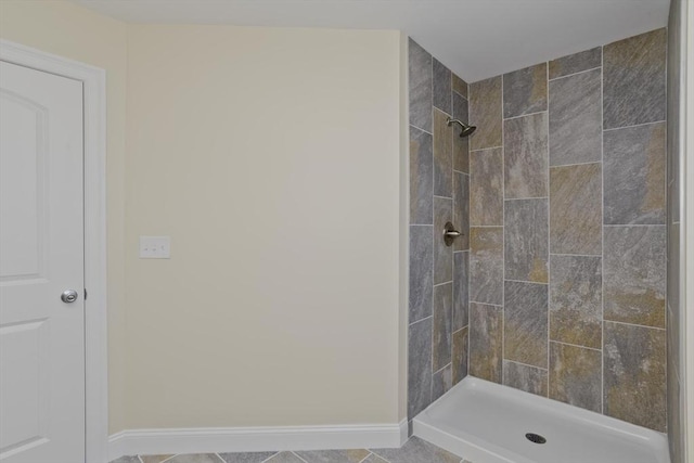 bathroom featuring tile patterned floors and tiled shower