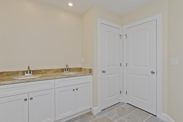 bathroom with tile patterned flooring and vanity