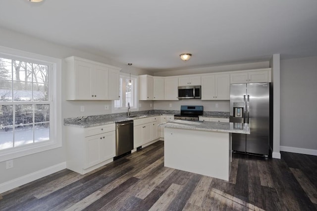 kitchen featuring pendant lighting, white cabinetry, stainless steel appliances, and sink