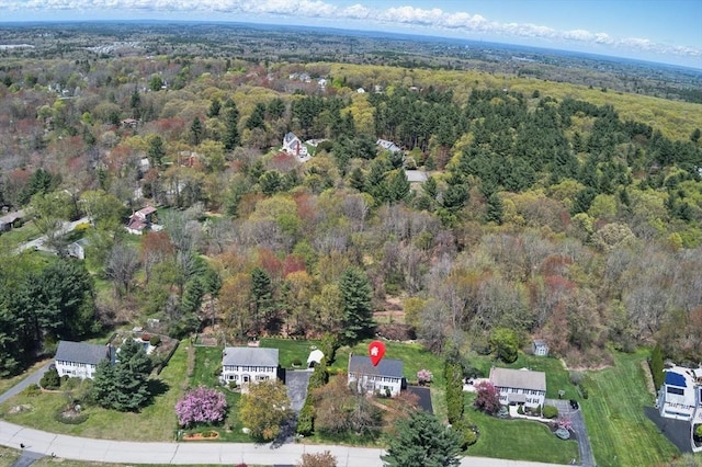 aerial view of property's location featuring a heavily wooded area