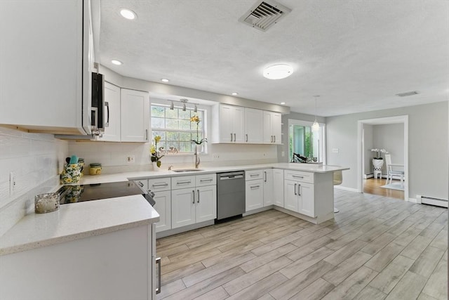 kitchen featuring dishwasher, a peninsula, a baseboard radiator, plenty of natural light, and recessed lighting