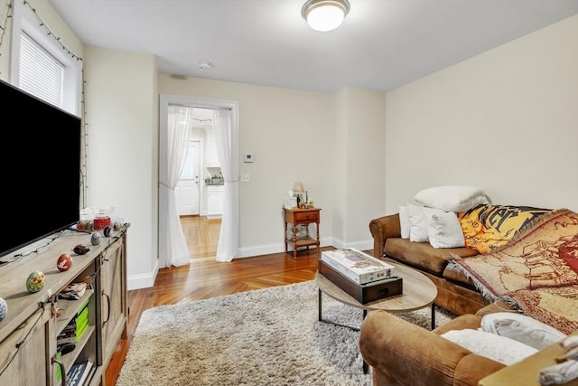 living room with light wood finished floors and baseboards