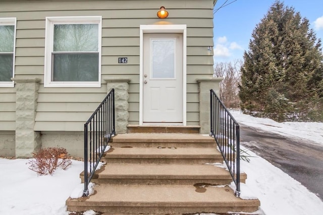 view of snow covered property entrance