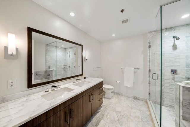 580 Washington St Unit 901, Boston, MA 02111 - bathroom featuring double vanity, marble look tile flooring, a marble finish shower, toilet, and recessed lighting