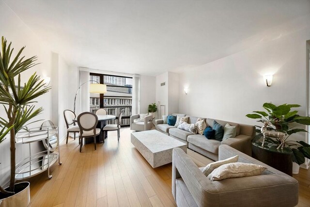 580 Washington St Unit 901, Boston, MA 02111 - living area with light wood finished floors and expansive windows