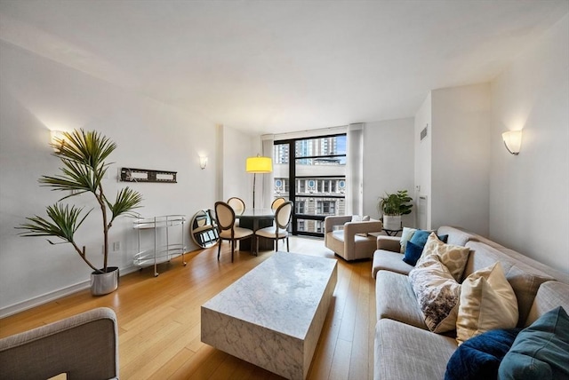 580 Washington St Unit 901, Boston, MA 02111 - living room with light wood-style flooring and floor to ceiling windows