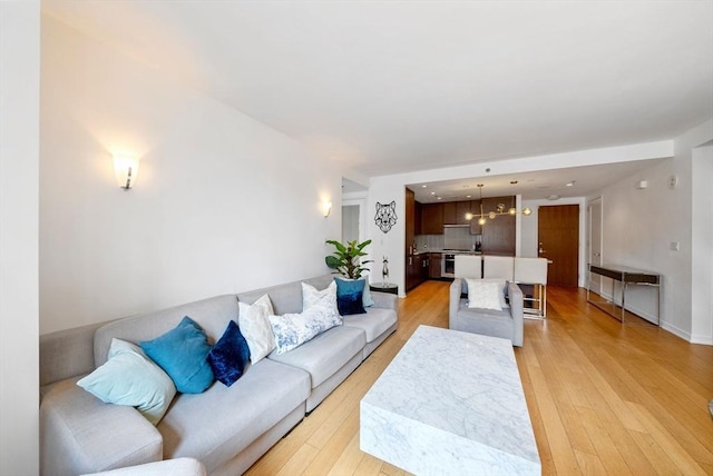 580 Washington St Unit 901, Boston, MA 02111 - living room featuring light wood-style flooring and a chandelier