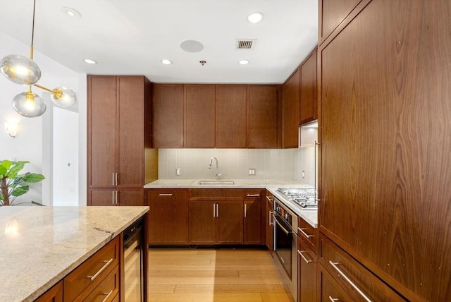 580 Washington St Unit 901, Boston, MA 02111 - kitchen featuring beverage cooler, light wood-style floors, a sink, light stone countertops, and tasteful backsplash