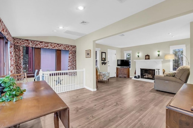 living room with hardwood / wood-style floors and vaulted ceiling