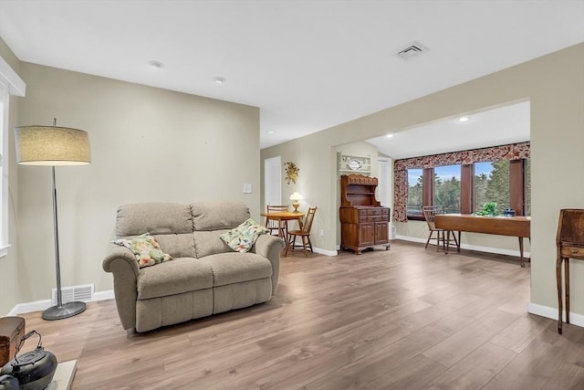 living room with light hardwood / wood-style flooring