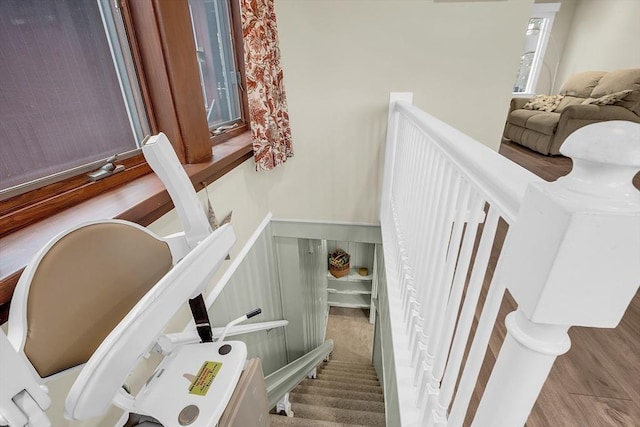 stairs featuring hardwood / wood-style floors