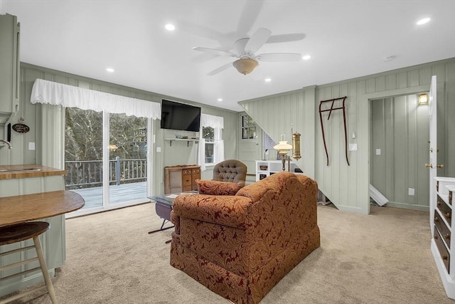 living room featuring light colored carpet, ceiling fan, and sink