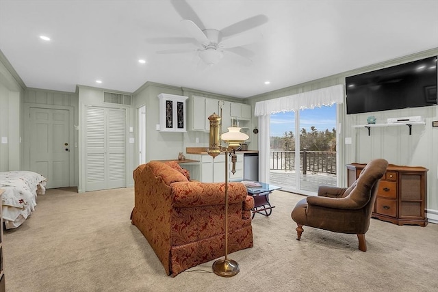 carpeted living room with ceiling fan