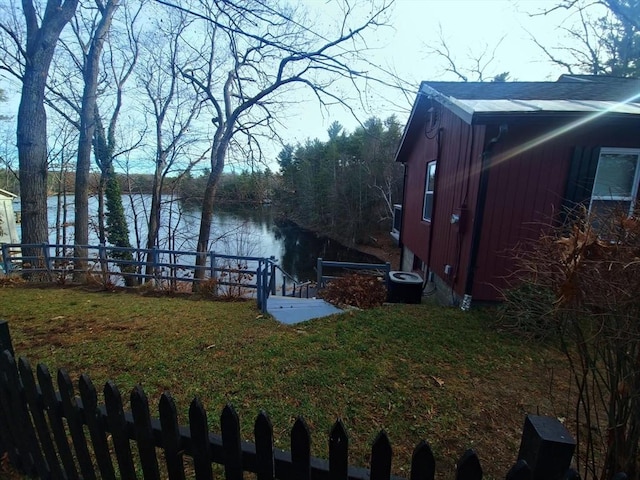 view of yard featuring cooling unit and a water view