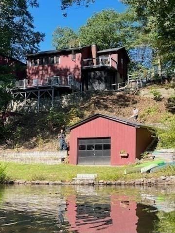 rear view of house with an outbuilding and a water view