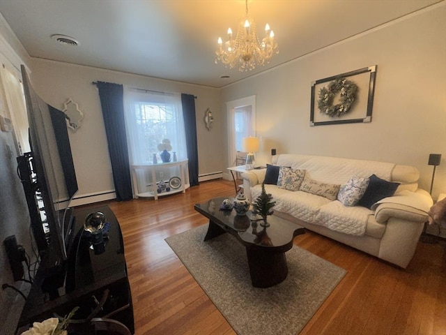 living room with wood-type flooring, a baseboard heating unit, and an inviting chandelier