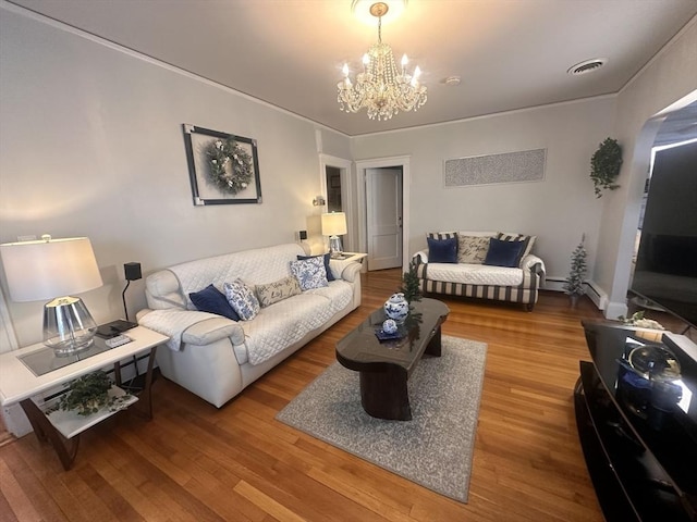 living room featuring an inviting chandelier and hardwood / wood-style floors