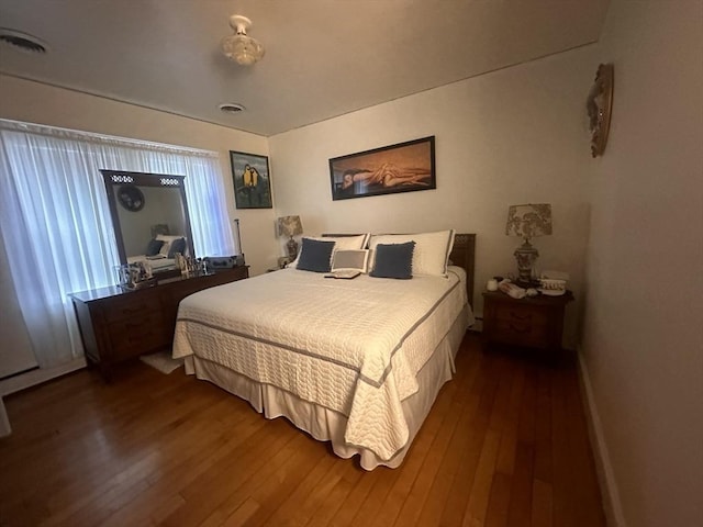 bedroom with hardwood / wood-style floors