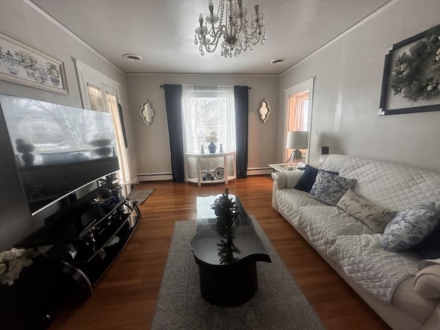 living room featuring hardwood / wood-style flooring, a baseboard radiator, ornamental molding, and a chandelier