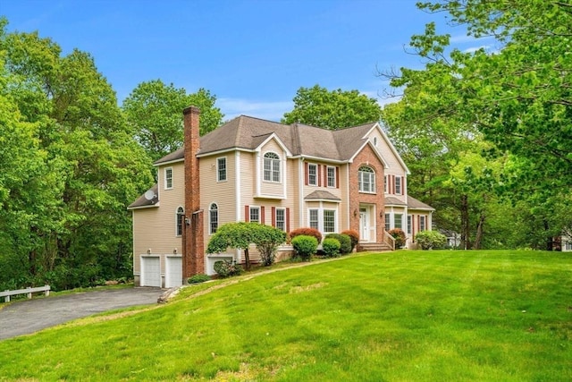 30 Sherwood Dr, North Andover, MA 01845 - colonial-style house featuring a chimney, asphalt driveway, an attached garage, and a front yard