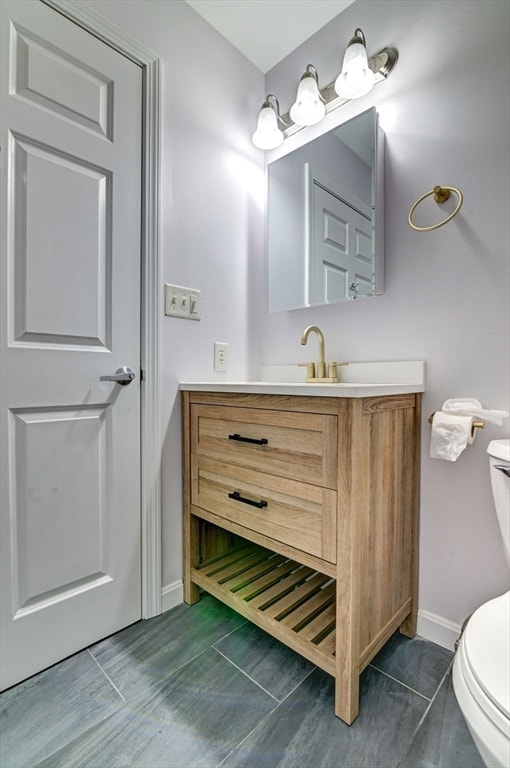 bathroom with toilet and vanity