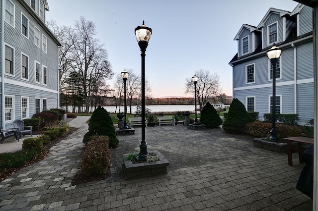 view of property's community with a patio and a water view