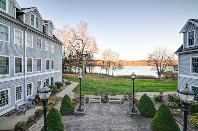 exterior space with a water view and a patio area