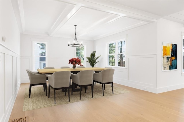 7 Bennett St, Natick, MA 01760 - dining space with a decorative wall, light wood-type flooring, plenty of natural light, a chandelier, and beamed ceiling