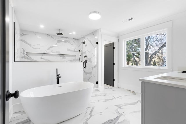 7 Bennett St, Natick, MA 01760 - bathroom featuring marble finish floors, a marble finish shower, vanity, a freestanding tub, and recessed lighting