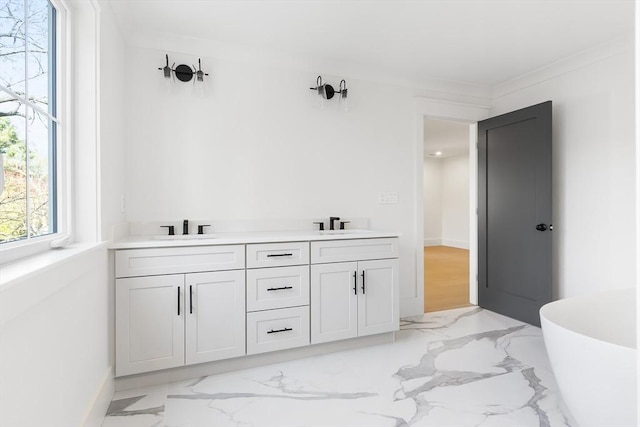 7 Bennett St, Natick, MA 01760 - bathroom featuring a freestanding bath, double vanity, and marble finish floors