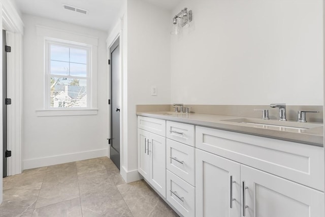 7 Bennett St, Natick, MA 01760 - bathroom featuring double vanity and baseboards