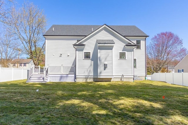7 Bennett St, Natick, MA 01760 - back of property featuring a deck, a fenced backyard, and roof with shingles