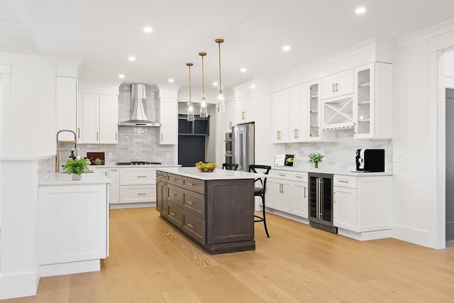 7 Bennett St, Natick, MA 01760 - kitchen with beverage cooler, wall chimney range hood, decorative backsplash, white cabinetry, and recessed lighting