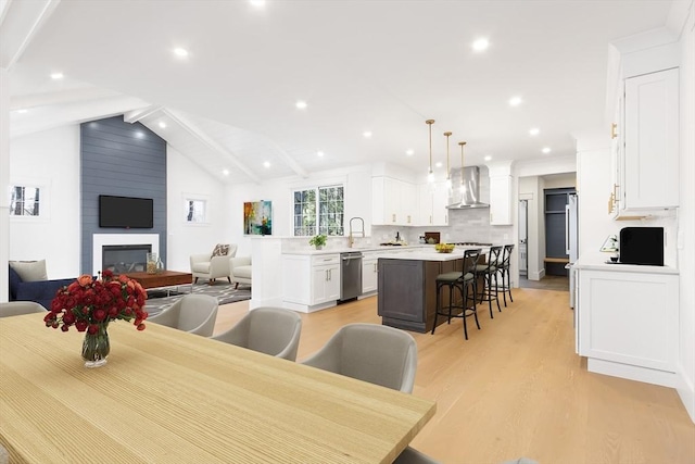 7 Bennett St, Natick, MA 01760 - dining area with light wood-style flooring, recessed lighting, and a fireplace