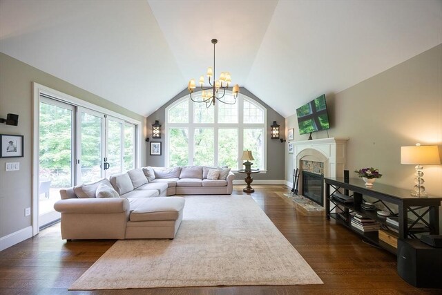 5 Copperbeech Cir, Westborough, MA 01581 - living area featuring a fireplace with flush hearth, a chandelier, lofted ceiling, baseboards, and dark wood finished floors