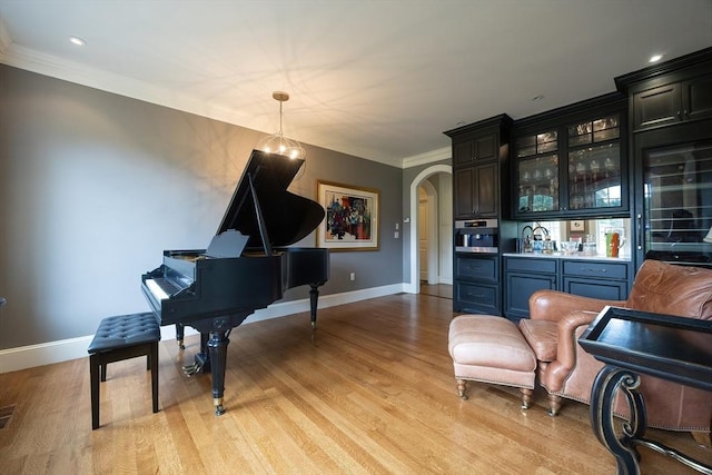 5 Copperbeech Cir, Westborough, MA 01581 - living area with bar with sink, arched walkways, light wood-style floors, baseboards, and crown molding