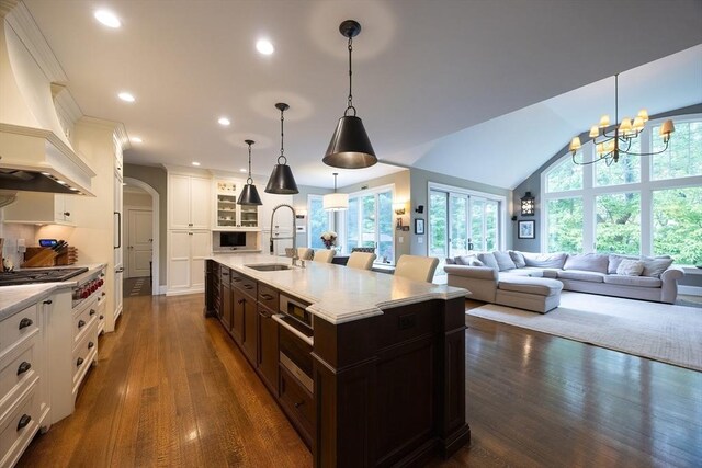 5 Copperbeech Cir, Westborough, MA 01581 - kitchen with a sink, stainless steel gas stovetop, arched walkways, light countertops, and recessed lighting