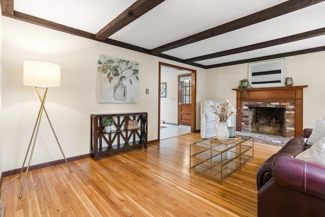 52 Diana Dr, Marlborough, MA 01752 - living area with light wood finished floors, beam ceiling, and a fireplace