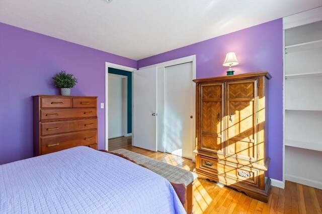 bedroom featuring baseboards and wood finished floors