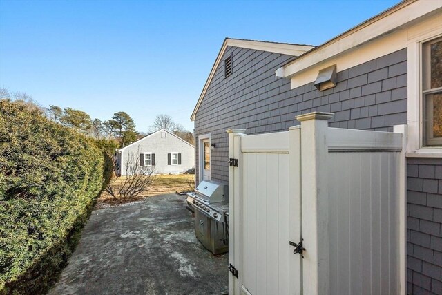 view of side of home with a patio