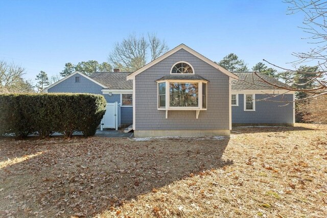 back of property with a shingled roof